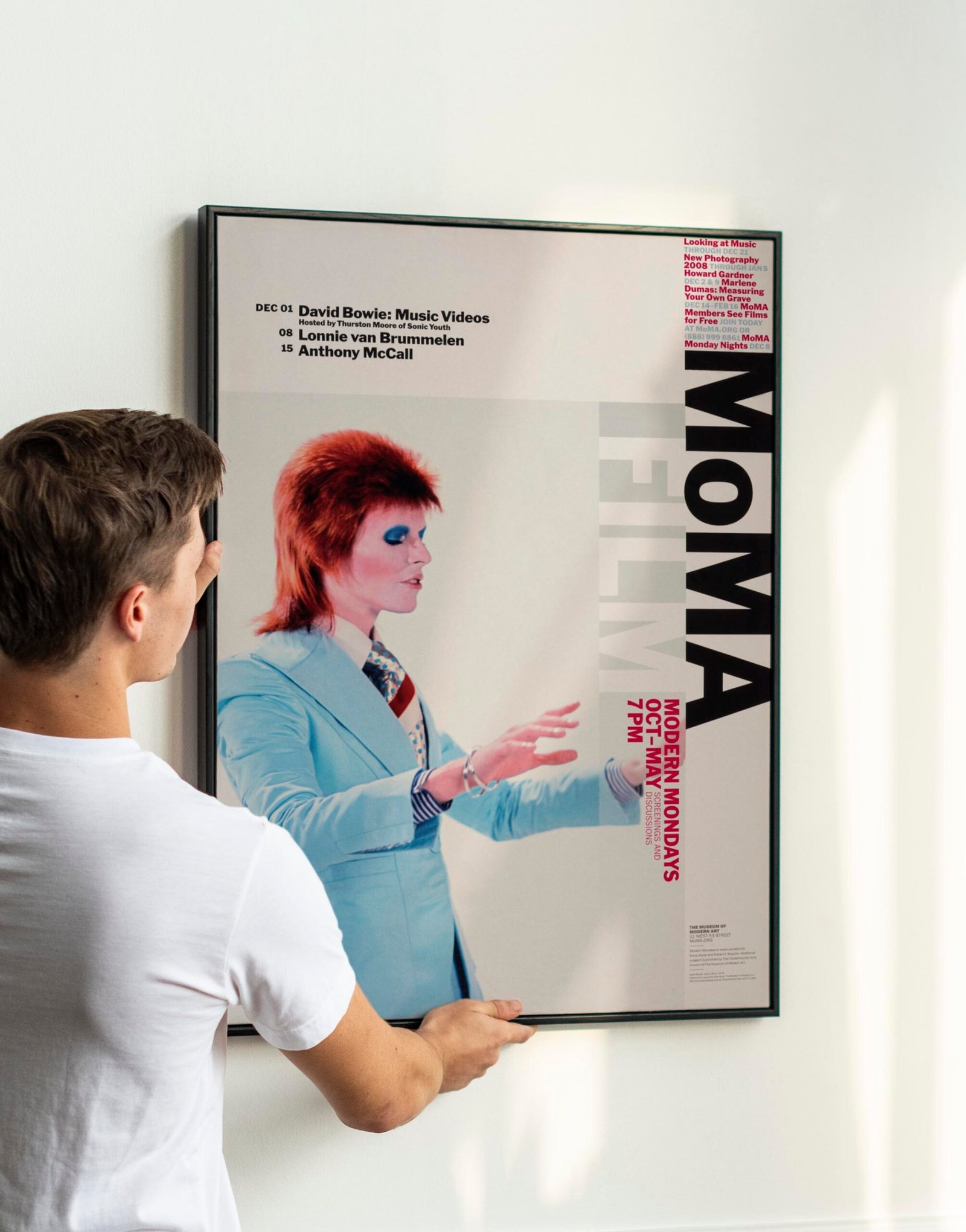 Vintage leaf painting frame psd being hung by a young man on a w